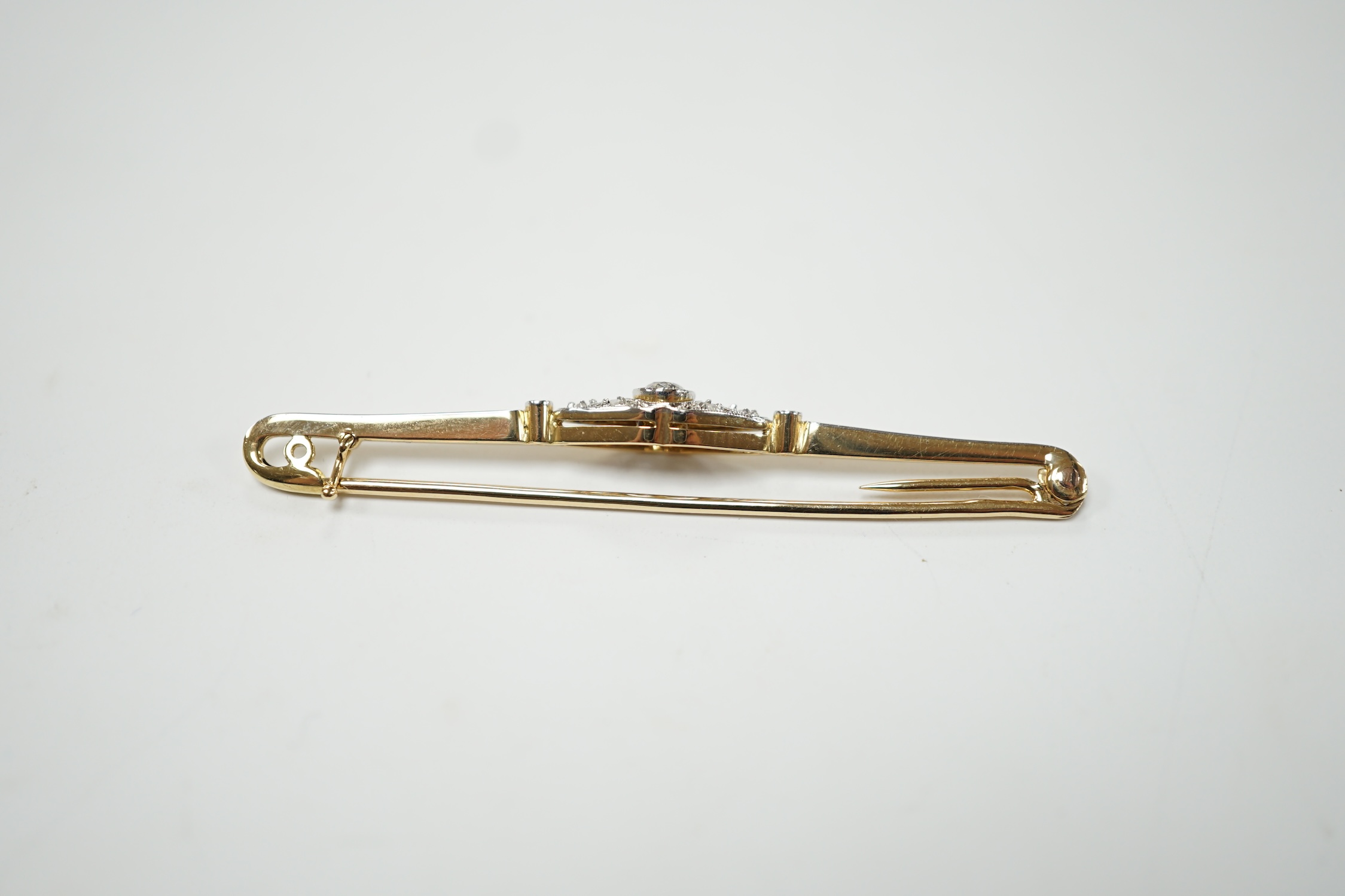 An Edwardian yellow metal and diamond cluster set bar brooch, 55mm, gross weight 3.6 grams. Condition - good